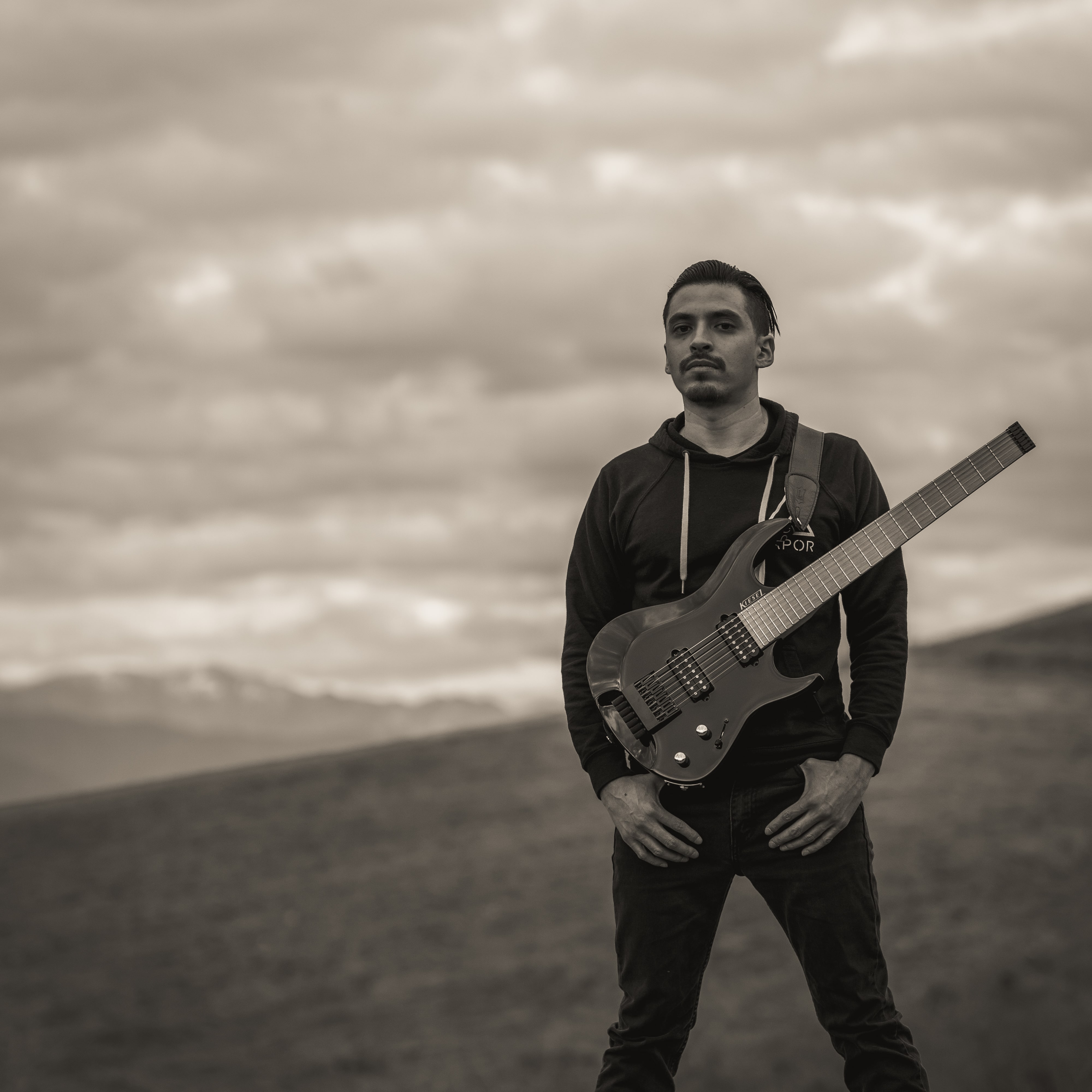 Sebastian Sampson outdoors holding his guitar